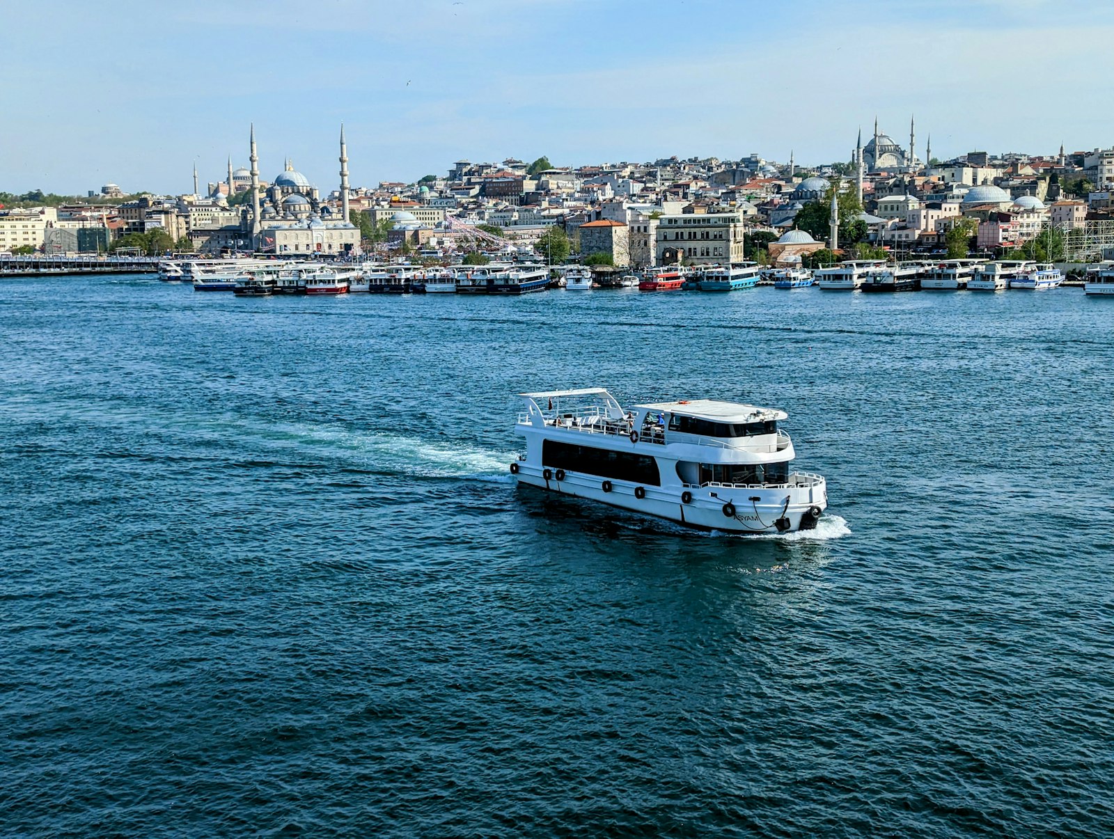 Cruise boat on the Bosphorus with Istanbul skyline in the background