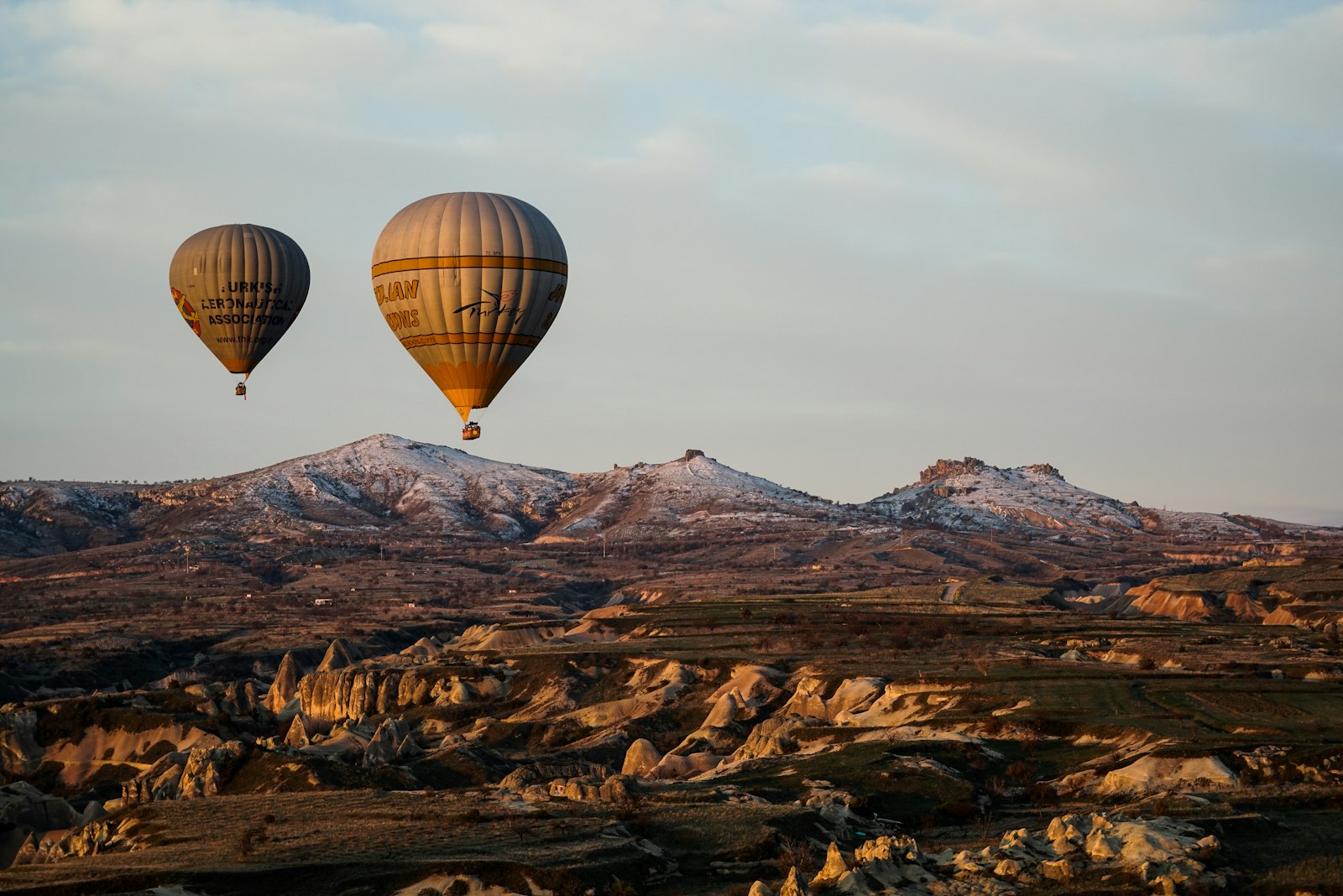 Hot air balloons floating over Cappadocia at sunrise