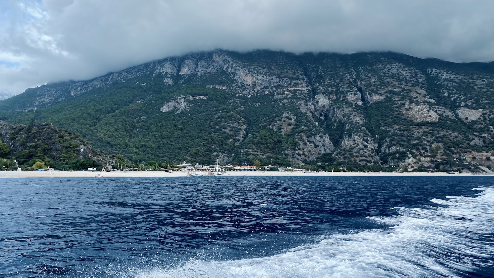 Ölüdeniz coastline with deep blue water and mountain backdrop